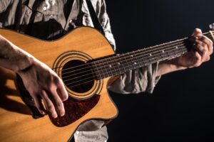 man playing an acoustic guitar