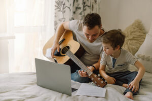 father and sun bond over playing guitar